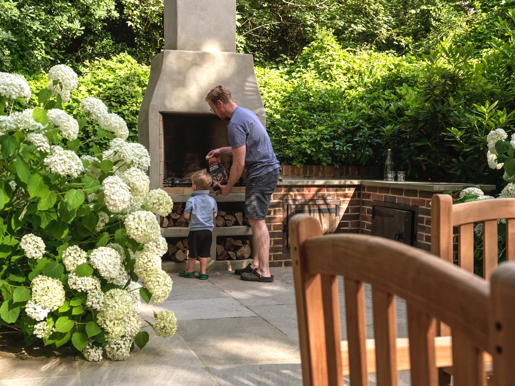 Father and son lighting the stove on the upper terrace